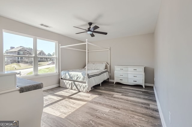 bedroom with dark wood-type flooring and ceiling fan