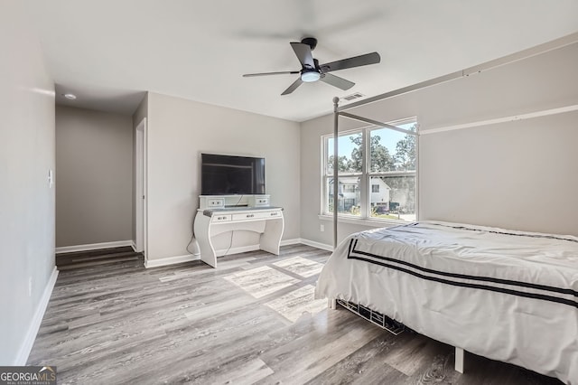 bedroom with light hardwood / wood-style floors and ceiling fan