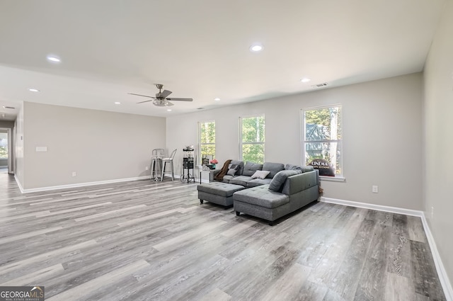 living room featuring ceiling fan and light hardwood / wood-style flooring