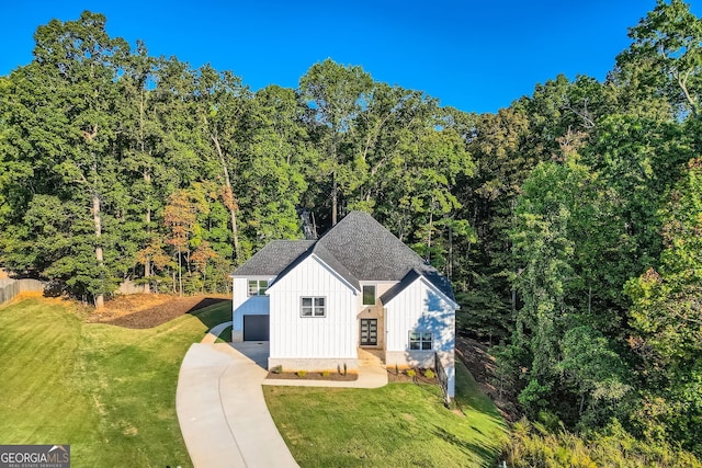 view of front of home with a front lawn and a garage