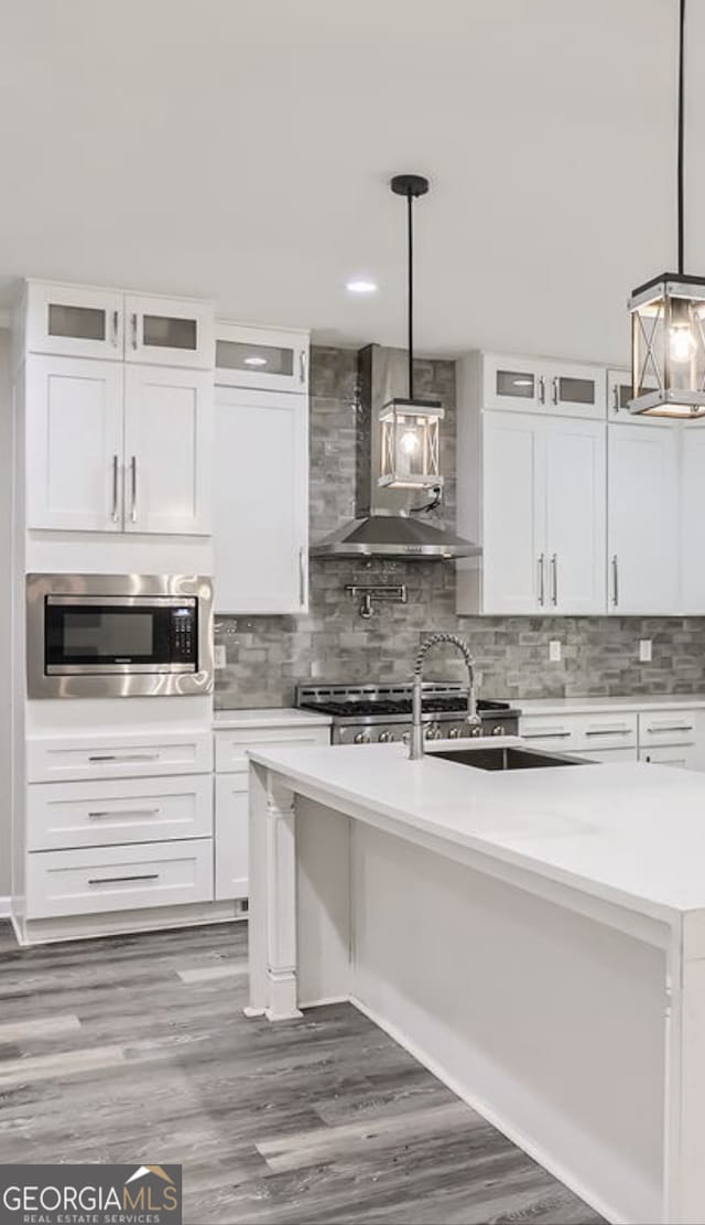 kitchen featuring white cabinets and hanging light fixtures