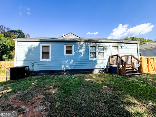 rear view of property with a yard and a deck