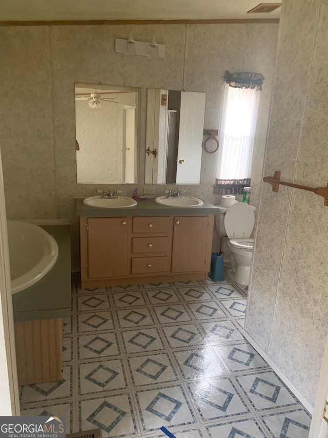 bathroom with toilet, vanity, and ceiling fan