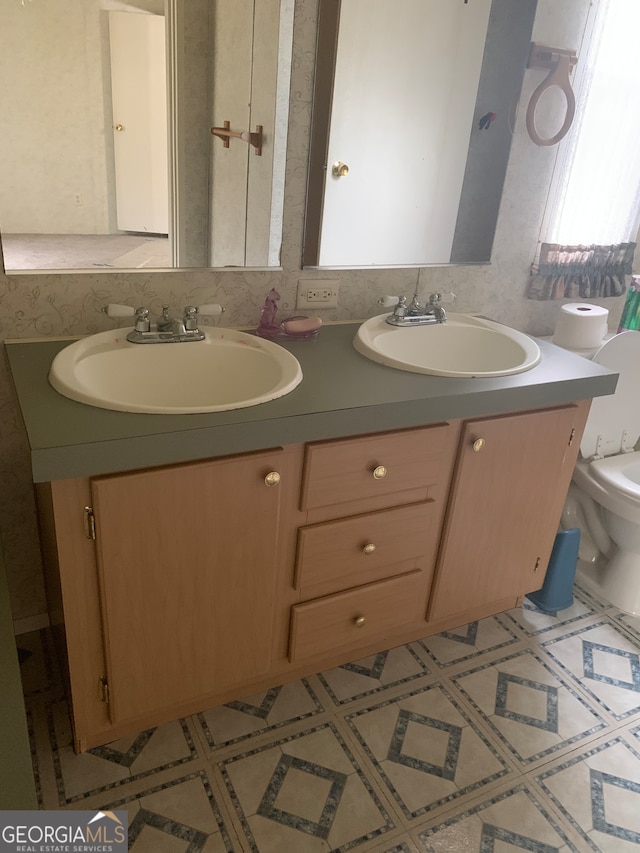 bathroom featuring vanity and toilet