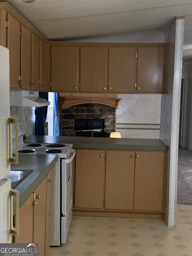 kitchen featuring a stone fireplace, white electric stove, and vaulted ceiling