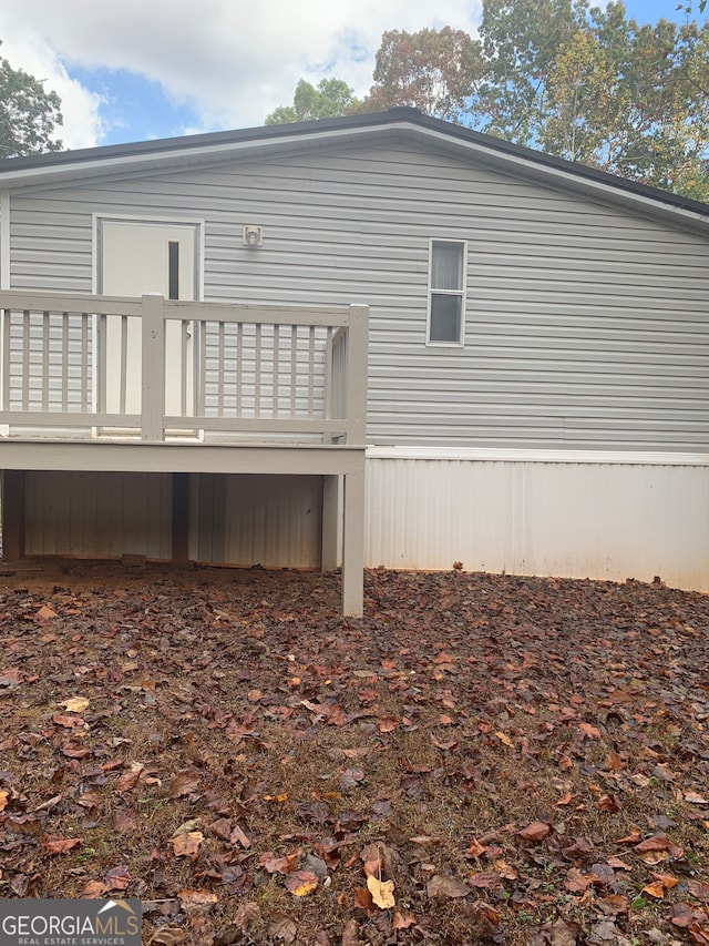 back of property featuring a wooden deck