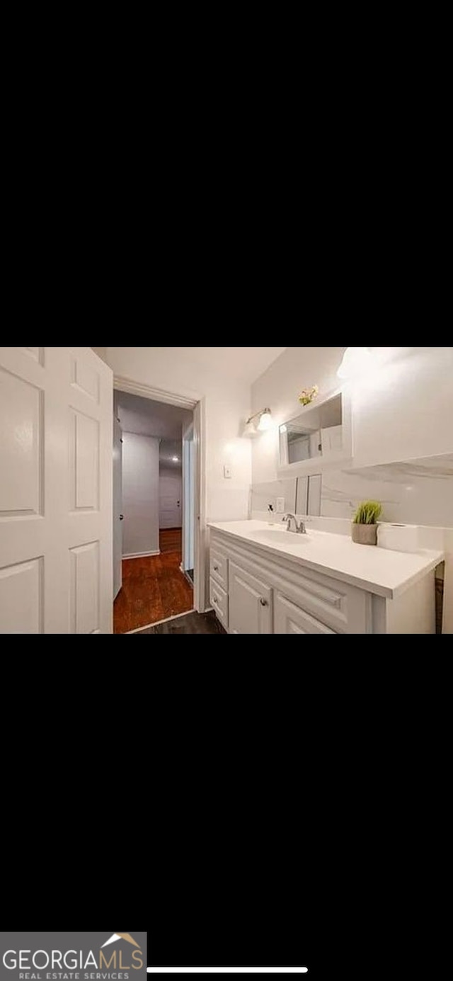 bathroom featuring vanity and hardwood / wood-style floors