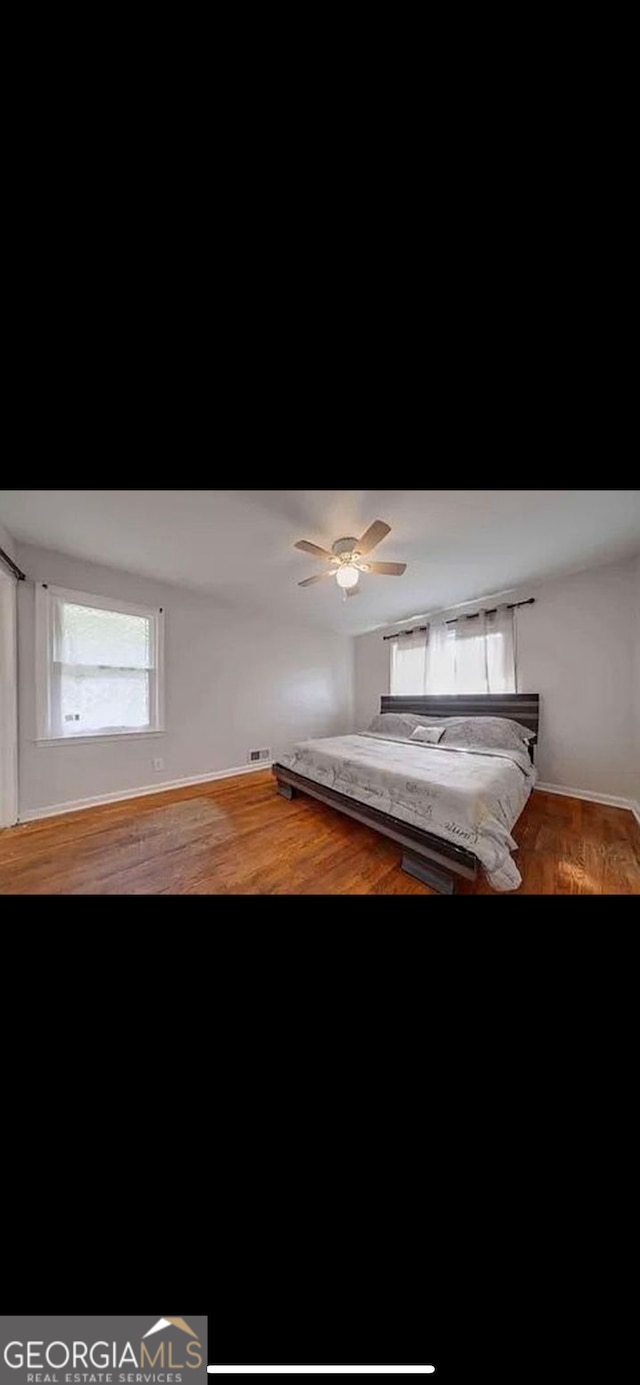 unfurnished bedroom with hardwood / wood-style floors and ceiling fan