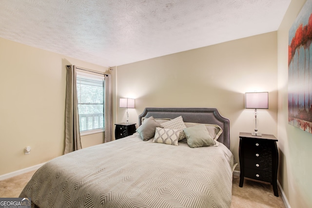 carpeted bedroom featuring a textured ceiling