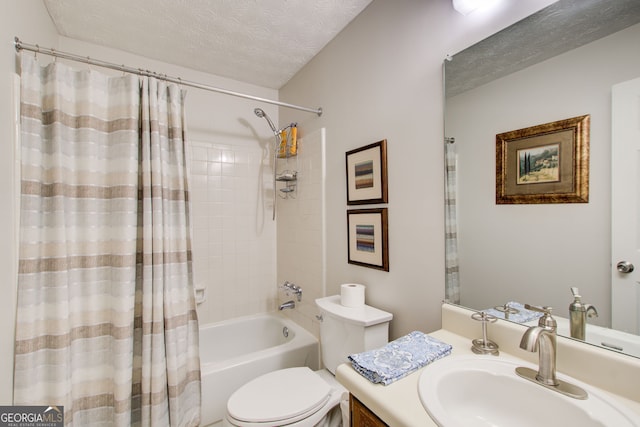 full bathroom featuring vanity, toilet, a textured ceiling, and shower / bath combo