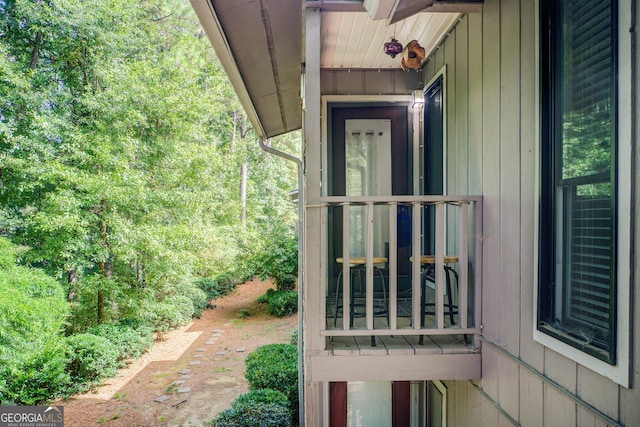 view of exterior entry with a balcony