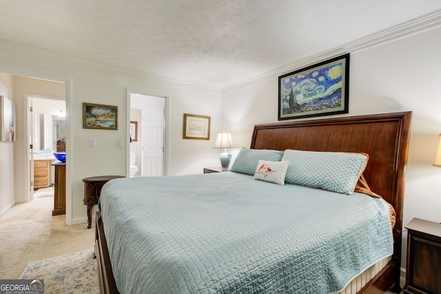 bedroom featuring ensuite bathroom, crown molding, a textured ceiling, and light colored carpet