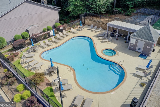 view of pool featuring a patio area and a community hot tub