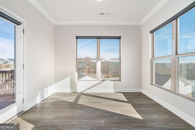 unfurnished room with ornamental molding and dark wood-type flooring