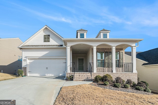 view of front of home featuring covered porch and a garage