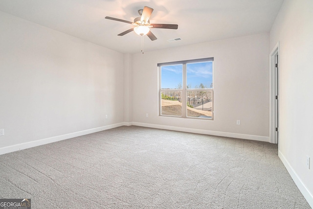 carpeted empty room featuring ceiling fan