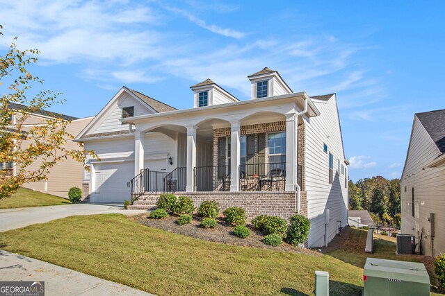 view of front of home featuring a porch, a garage, and cooling unit