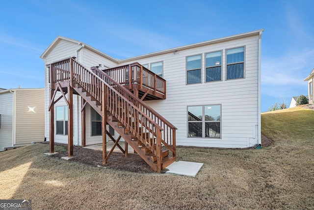 rear view of property with a yard and a deck