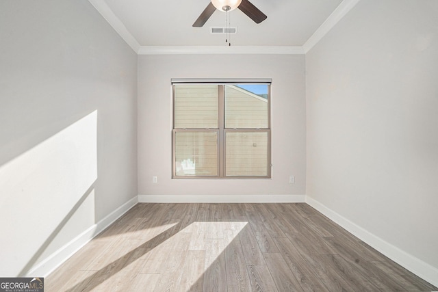 spare room with crown molding, ceiling fan, and light hardwood / wood-style floors