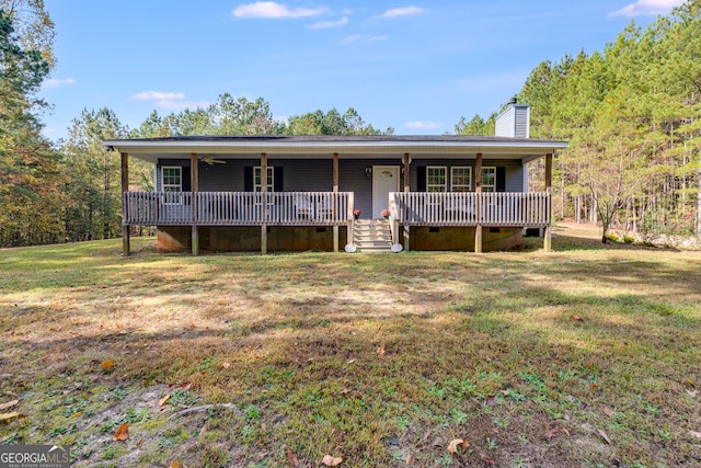 ranch-style house with a wooden deck and a front lawn