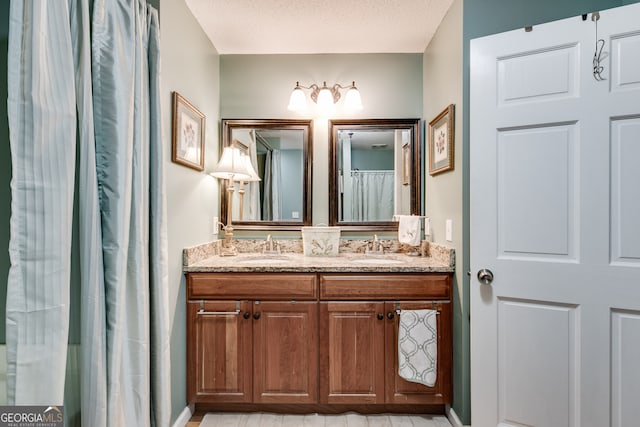 bathroom with vanity and a textured ceiling