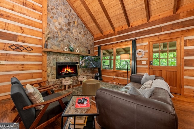 living room featuring high vaulted ceiling, wood-type flooring, a fireplace, wooden ceiling, and beamed ceiling