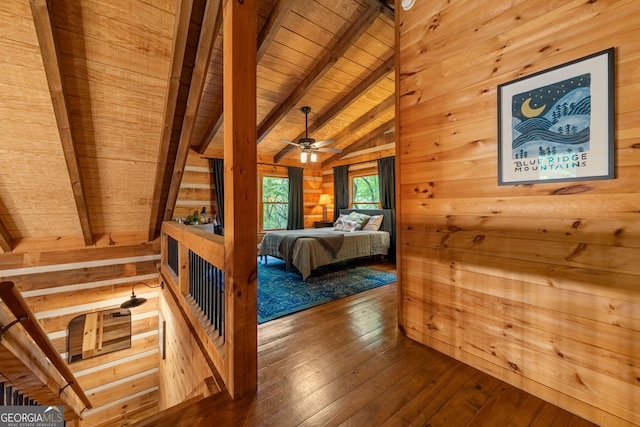 bedroom featuring wood ceiling, wood-type flooring, lofted ceiling with beams, and wood walls