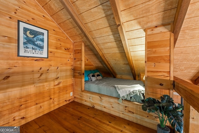 unfurnished bedroom with vaulted ceiling with beams, wooden walls, wooden ceiling, and wood-type flooring