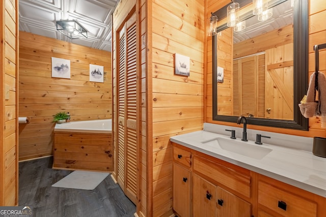 bathroom featuring vanity, hardwood / wood-style floors, and wooden walls