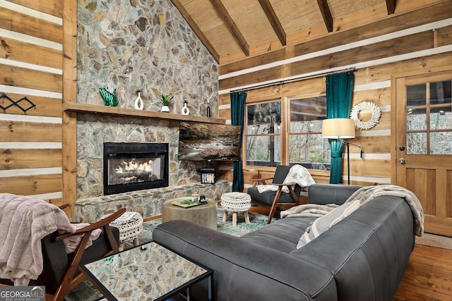 living room with a stone fireplace, hardwood / wood-style floors, wooden walls, wood ceiling, and beam ceiling