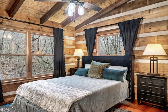 bedroom with ceiling fan, wooden ceiling, dark hardwood / wood-style flooring, and wood walls