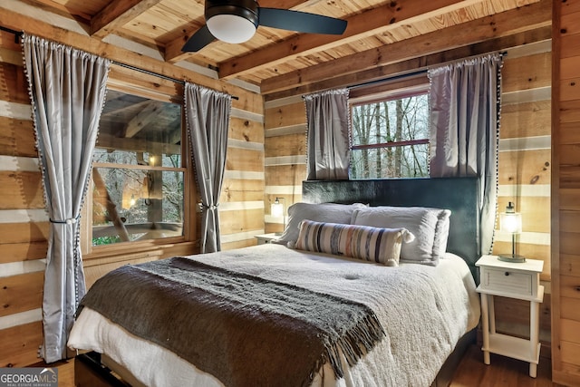 bedroom with ceiling fan, hardwood / wood-style floors, wood ceiling, and wood walls