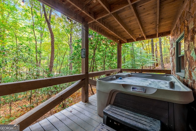 wooden deck with a hot tub