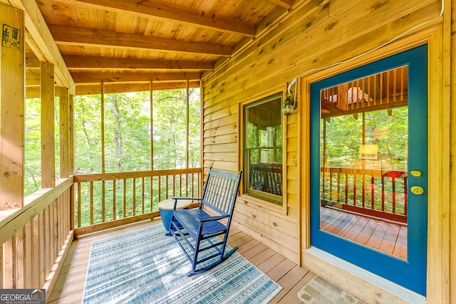 sunroom featuring wood ceiling and beamed ceiling