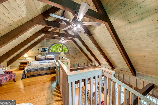 bedroom featuring vaulted ceiling with beams, wood ceiling, hardwood / wood-style flooring, and wooden walls