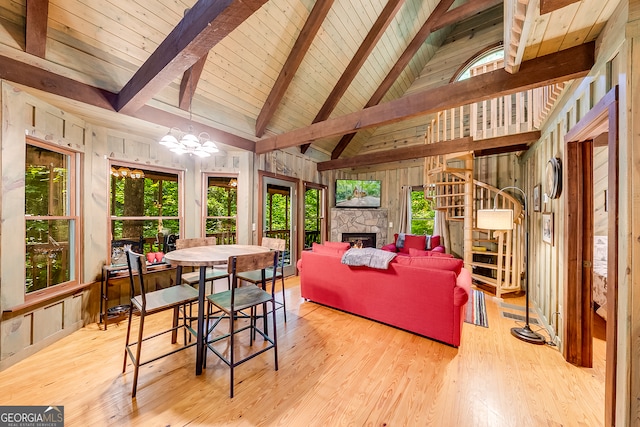 living room with wooden walls and light hardwood / wood-style flooring