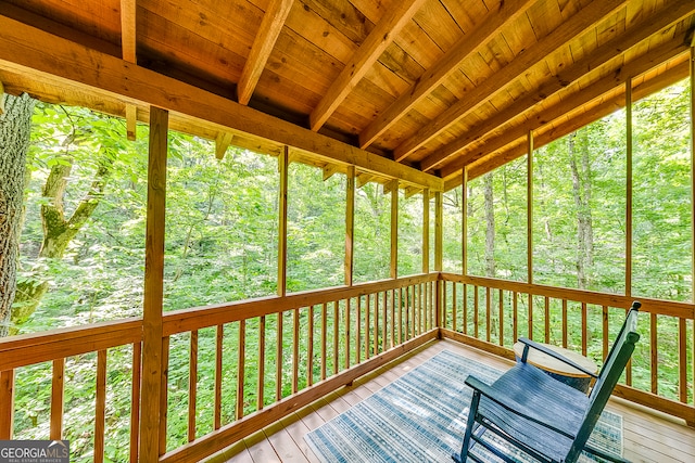 unfurnished sunroom with wood ceiling and beamed ceiling