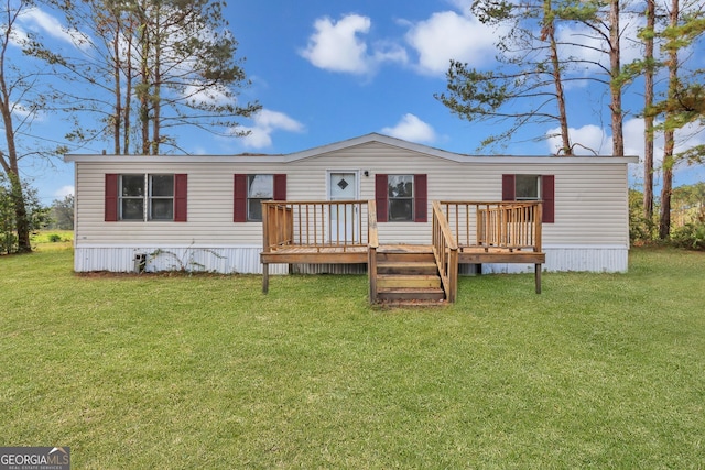 back of property featuring a deck and a lawn