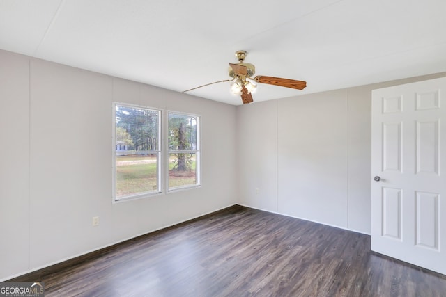 empty room featuring ceiling fan and dark hardwood / wood-style flooring