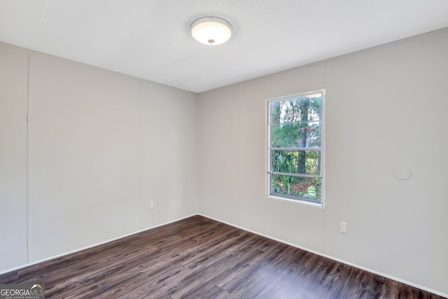 spare room featuring dark hardwood / wood-style flooring