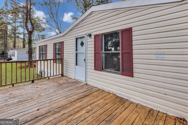 deck with a garage and an outbuilding