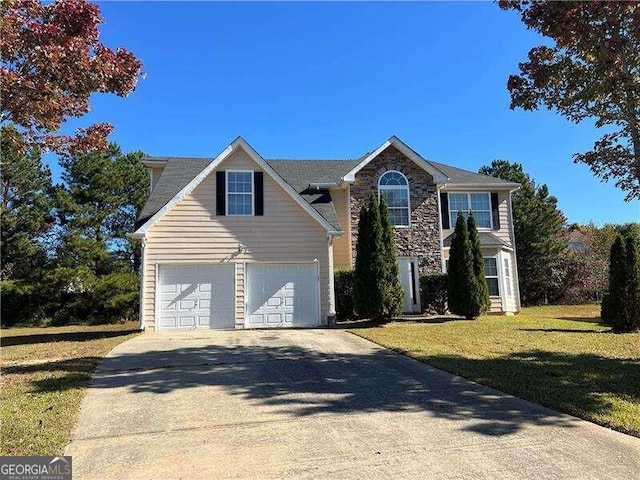 view of front of house featuring a front yard and a garage