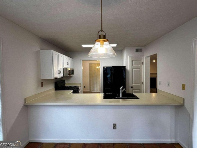 kitchen with black appliances, white cabinetry, kitchen peninsula, and decorative light fixtures