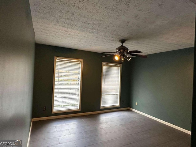 spare room featuring a textured ceiling and ceiling fan