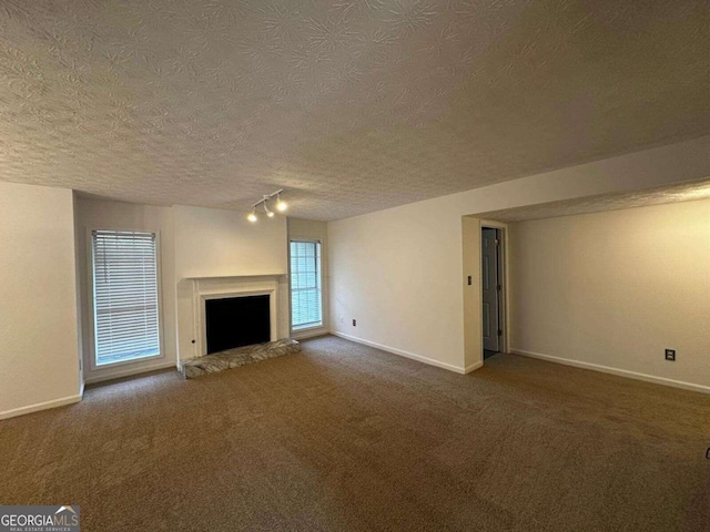 unfurnished living room featuring carpet and a textured ceiling