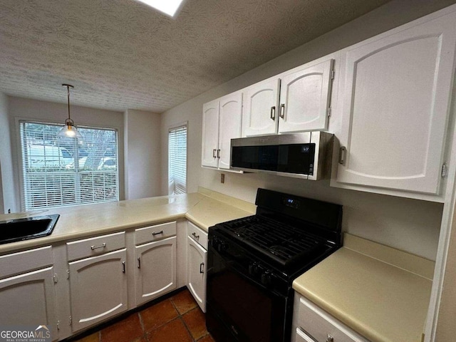 kitchen with a textured ceiling, white cabinets, pendant lighting, and black gas range oven