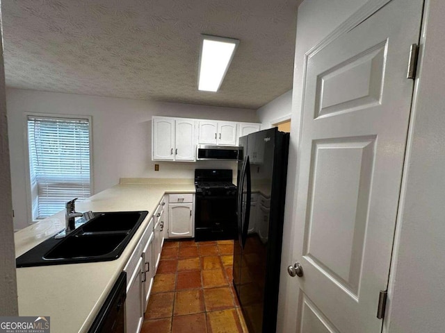 kitchen featuring white cabinetry, a textured ceiling, black appliances, and sink