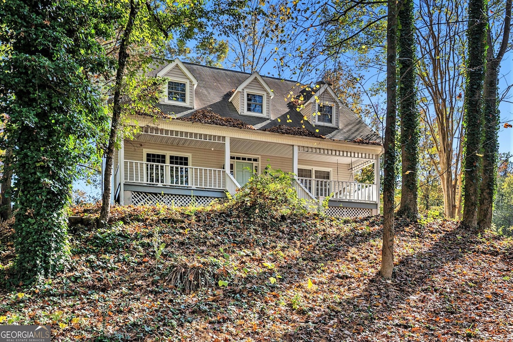 cape cod-style house with covered porch