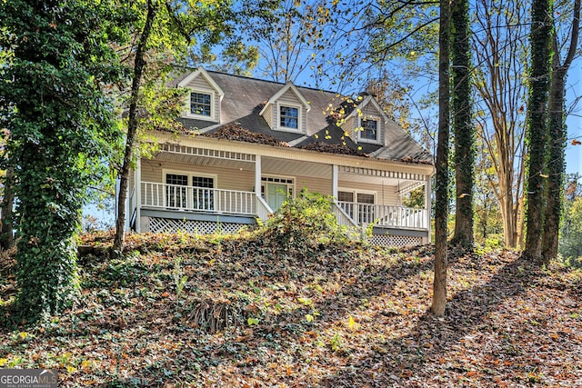 cape cod-style house with covered porch