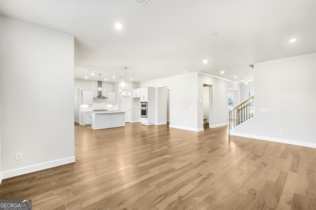 unfurnished living room with light hardwood / wood-style flooring